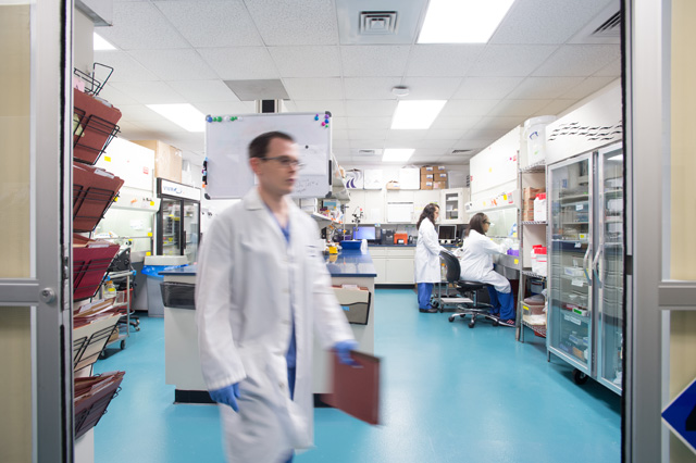 technician walking from laboratory